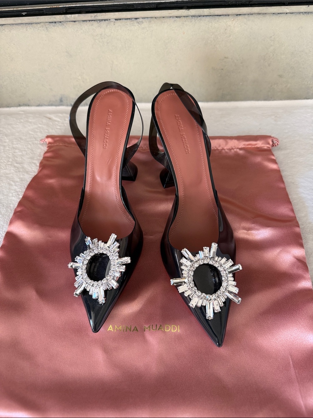 Amina Muaddi Black Slingback Pumps with Crystal Sunburst